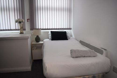 a bedroom with a white bed and a window at Studio Apartment Fully Equipeed with WiFi and Netflix in Ilkeston
