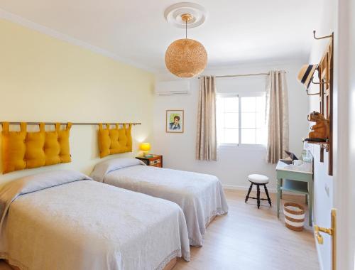 a bedroom with two beds and a window at Lumae Guesthouse in Lobres