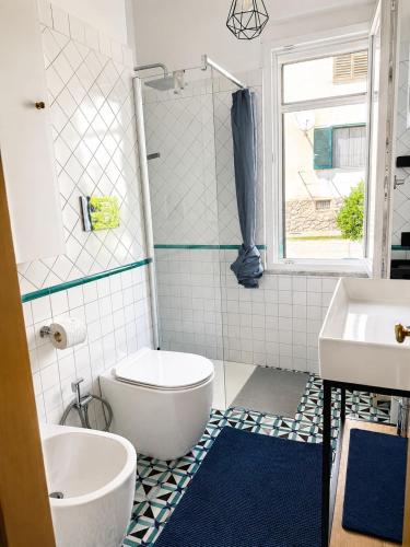 a bathroom with a toilet and a sink at Casa Mansi in Vietri sul Mare