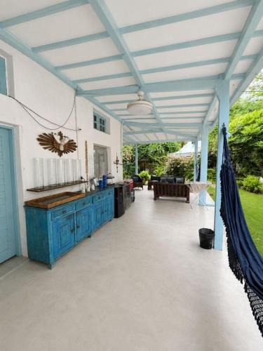 an outdoor patio with a blue table and awning at Estrela Praia in Fernando de Noronha