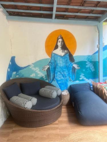 a room with a painting of a woman on the wall at Estrela Praia in Fernando de Noronha