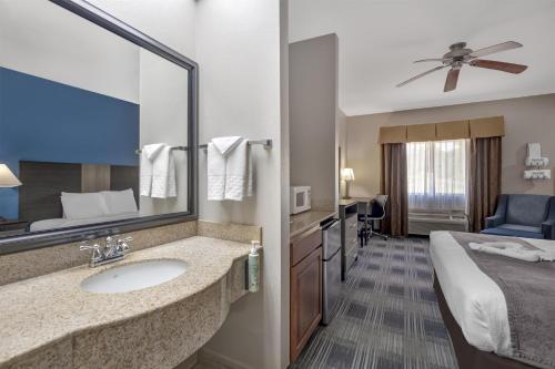 a hotel room with a sink and a bed at Best Western Geneseo Inn in Geneseo