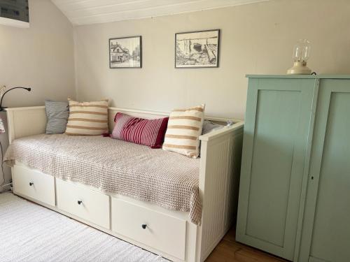 a bedroom with a bed with pillows on it at Hus Hultsnäs in Högsby