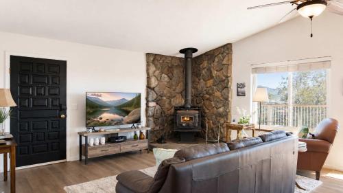 a living room with a couch and a fireplace at Copperopolis Home - Lake Access & Mtn Views in Copperopolis