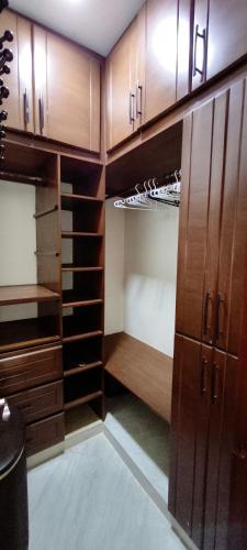 an empty kitchen with wooden cabinets and shelves at Caribbean Luxury Penthouse in San Felipe de Puerto Plata