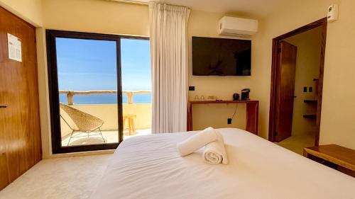 a bedroom with a bed with a view of the ocean at Hotel Boutique Alcalá Vallarta in Puerto Vallarta