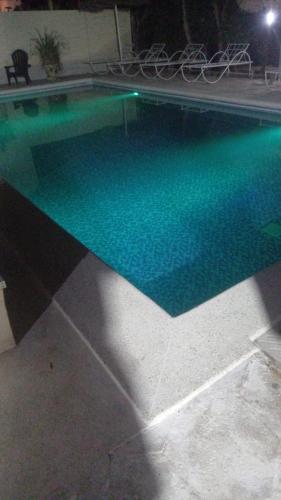 a swimming pool with green water in a house at Coin du paradis in Saly Portudal