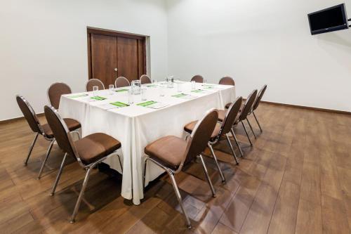 a conference room with a white table and chairs at Wyndham Garden Monterrey Norte in Monterrey