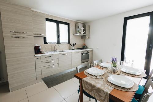 a kitchen with a table with two plates on it at Athena Garden House in Montesilvano