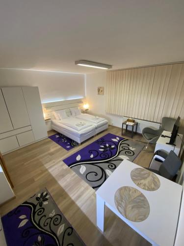 a small room with a bed and a couch at Apartmán Hollého 2 in Trenčín
