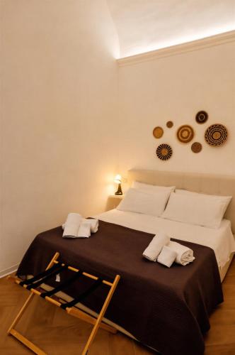 a bedroom with a large bed with a black blanket at Vicolo 25 in Cinisi