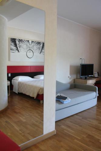 a bedroom with a bed and a television in it at Klass Hotel in Castelfidardo