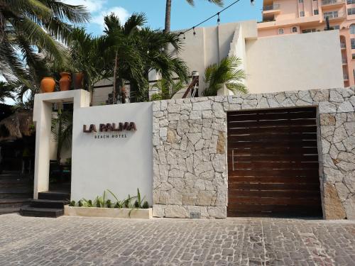 a building with a garage with a sign on it at La Palma Beachfront Hotel Boutique in Cancún