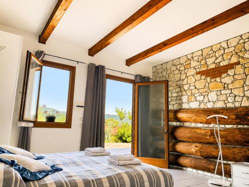 a bedroom with a bed and a stone wall at La Fontanella in Montecchia di Crosara