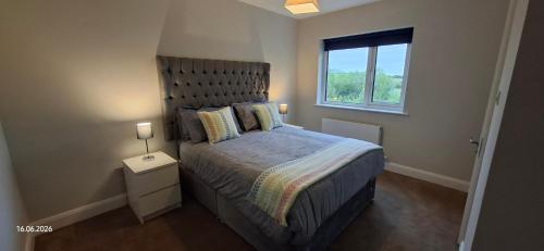 a bedroom with a large bed and a window at Rosmore Newport in Newport