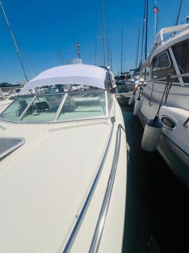 a white boat is docked in a harbor at VINA ROMANCE - Romantic Boat Stay in Lisbon Marina in Lisbon