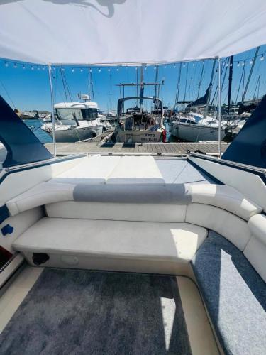 a boat is docked at a dock with boats at VINA ROMANCE - Romantic Boat Stay in Lisbon Marina in Lisbon
