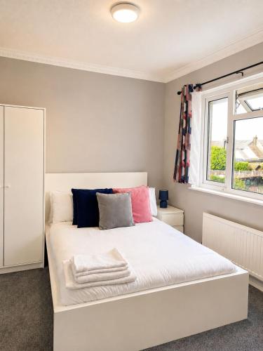 a white bed in a room with a window at 3-Bedroom House ,Quiet & Spacious in Kent