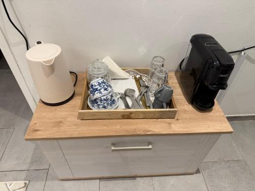 a wooden table with a tray of utensils on it at Eliasar2 in Linz