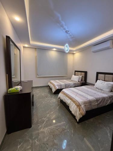 a room with two beds and a chalkboard in it at 3 BR apartment, fully renovated in Amman