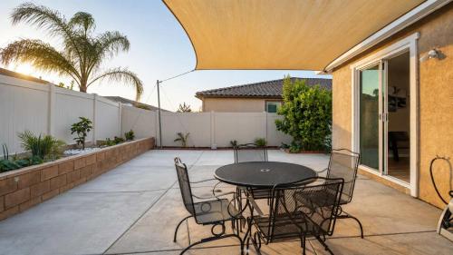 a patio with a table and chairs and a fence at Temecula Valley 4BR - Pool Table & Fenced Yard in Winchester