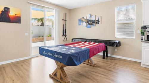 a room with a table with an american flag on it at Temecula Valley 4BR - Pool Table & Fenced Yard in Winchester