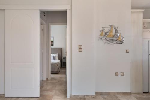 a hallway with white walls and a room with a bed at Pallas in Keratea