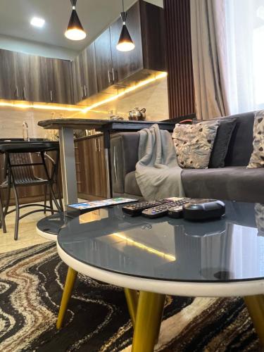 a living room with a couch and a table at Silver Homes Empiror in Kampala