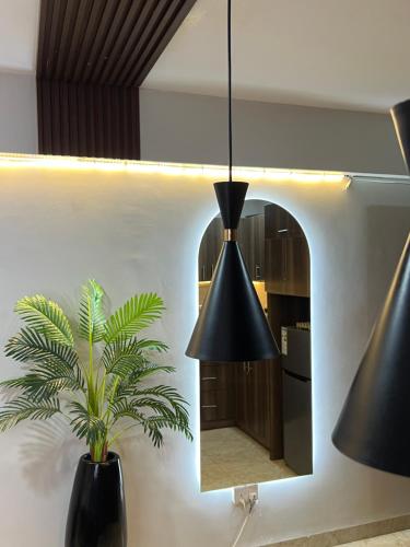 a black pendant light in a kitchen with a mirror at Silver Homes Empiror in Kampala