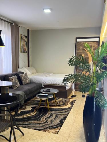 a living room with a couch and a table at Silver Homes Empiror in Kampala