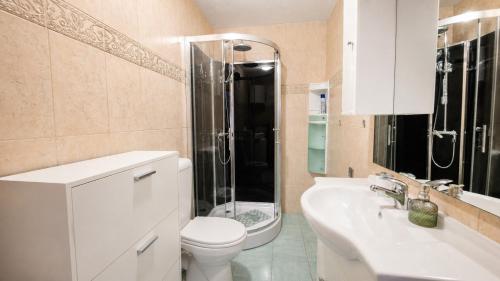 a bathroom with a toilet and a shower and a sink at Apartment Romić in Omiš