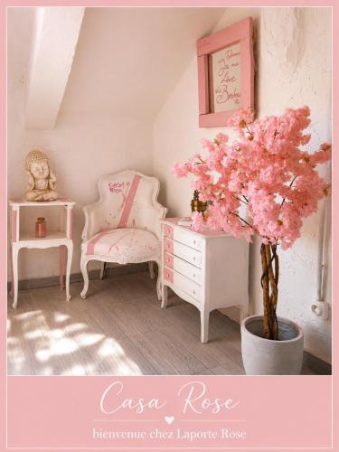 a room with a dresser and a tree with pink flowers at Casa Rose, Petit cocon avec jardin dans un quartier calme de Toulon in Toulon