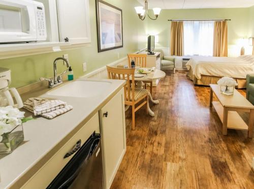 a kitchen and a living room with a bed at Holly Tree Resort - Studio in Yarmouth
