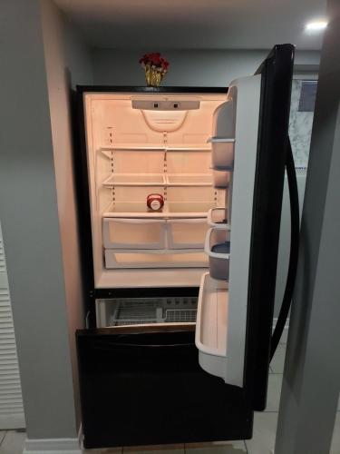 an empty refrigerator with its door open in a room at Beautiful home in Brampton
