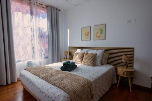 a bedroom with a bed with a teddy bear on it at La Maison Douce Lourdes in Lourdes