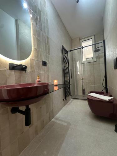 a bathroom with a sink and a toilet and a mirror at Amena Sea & City in Brindisi