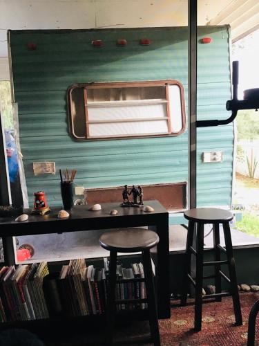 a table and two stools in front of a trailer at Tim Vales place in Tampa