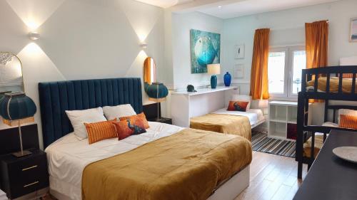 a bedroom with a bed and a chair in it at Villa Whiteloft Pool Spa Lounge in Corroios
