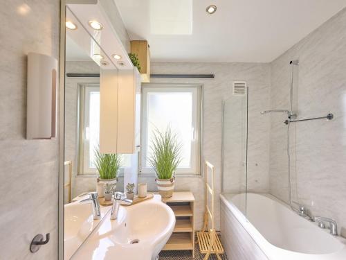 a bathroom with a tub and a sink and a tub and a bath tub at Barri in Zutendaal