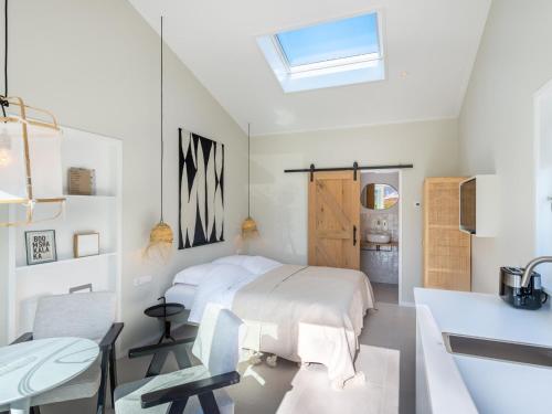 a bedroom with a bed and a desk and a sink at Zilte Suite in Oostkapelle