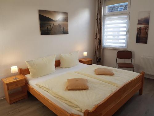 a bedroom with a large bed with two pillows on it at Altstadt Fairmietung in Wismar