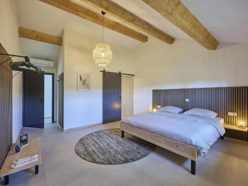 a bedroom with a large bed and a rug at Guesthouse het Koetshuis in Bladel