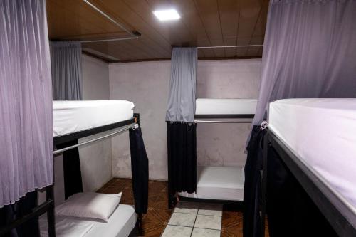 a group of bunk beds in a room at Blackout Party Hostel and Experiences in Fortuna