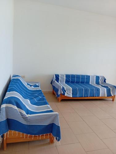 two beds sitting next to each other in a room at Résidence R in Ksour Essaf