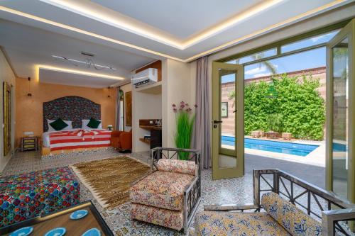 a hotel room with a bed and a pool at Jnane Rihane Marrakech in Marrakesh