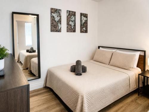 a bedroom with a bed and a large mirror at The Madison by the Gold Nests in Hollywood