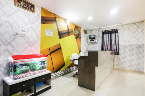 a bathroom with a fish tank in a room at Hotel O Priyal in Chās