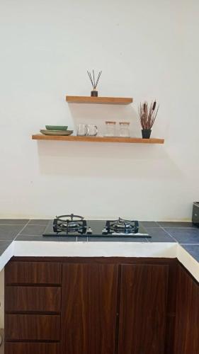a kitchen with a stove and a counter top at RUMAH BAIQ Villa in Kuta Lombok