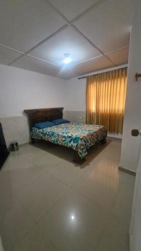 a bedroom with a bed in a room with a window at Villa Salguero in Gaira