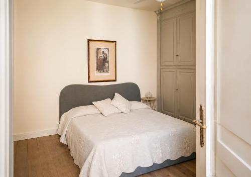 a bedroom with a bed with a gray headboard at Mare di Gioia in Viareggio